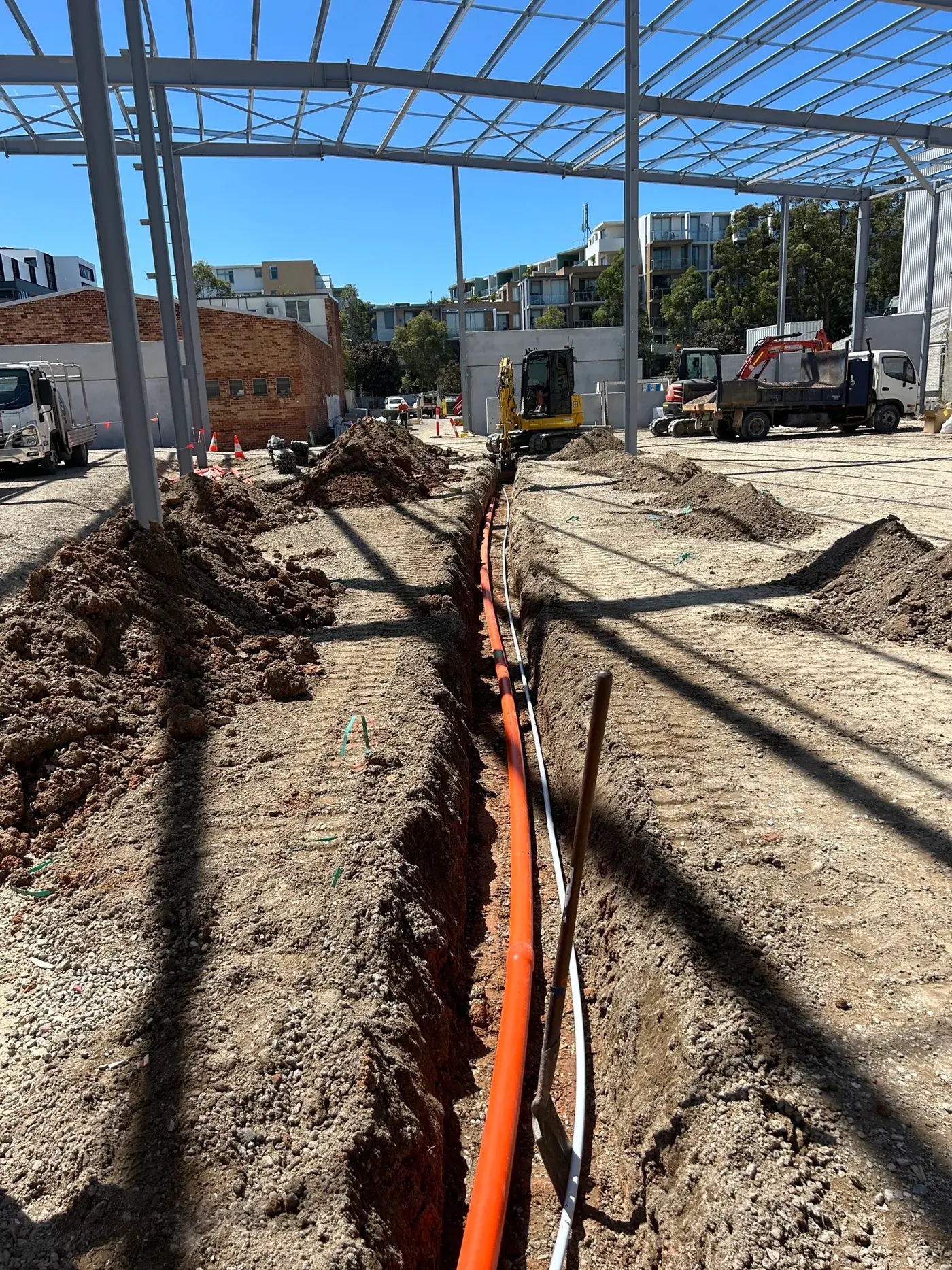 Before: trench and conduits on a bare commercial site