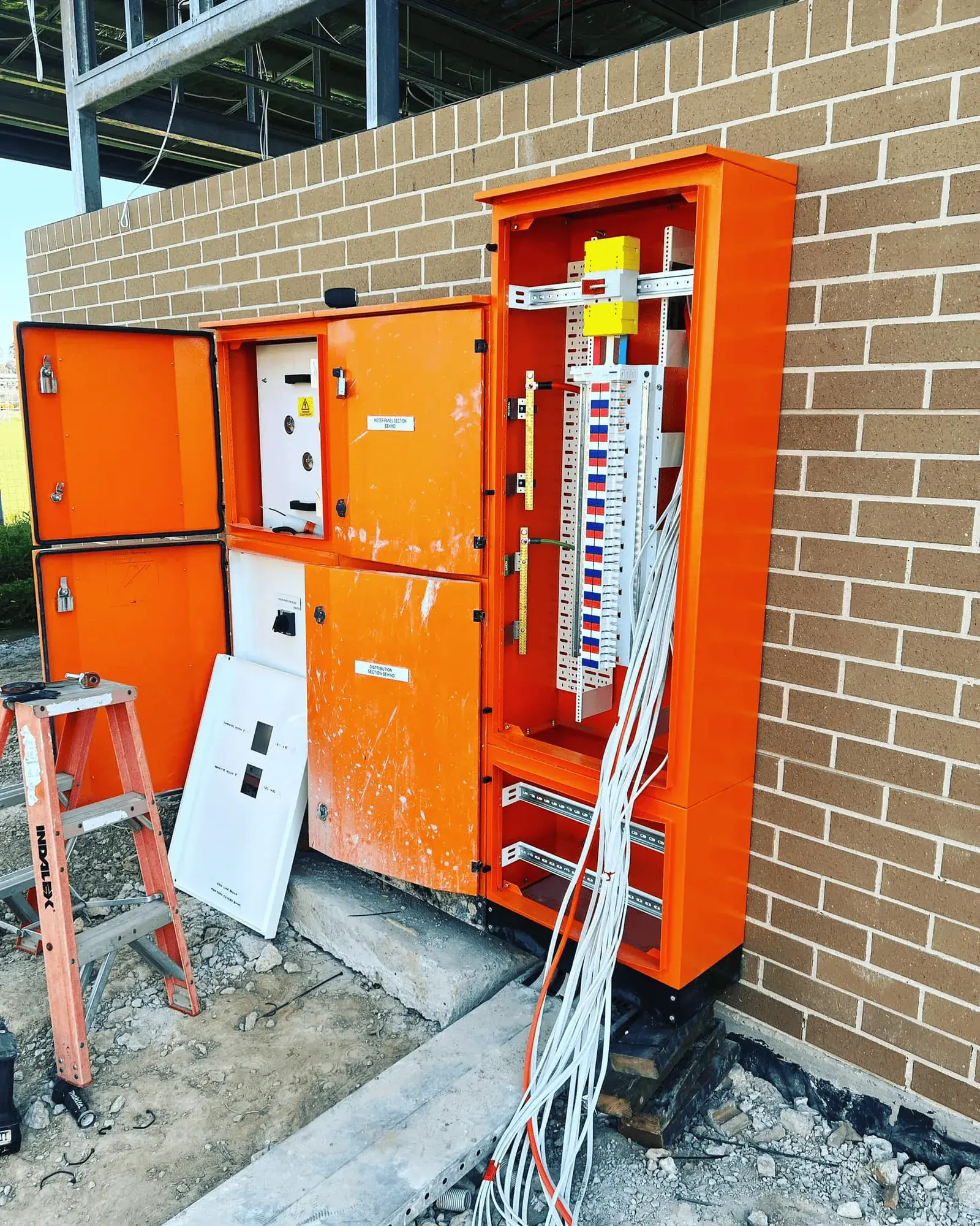 Commercial meter and distribution board in an orange enclosure