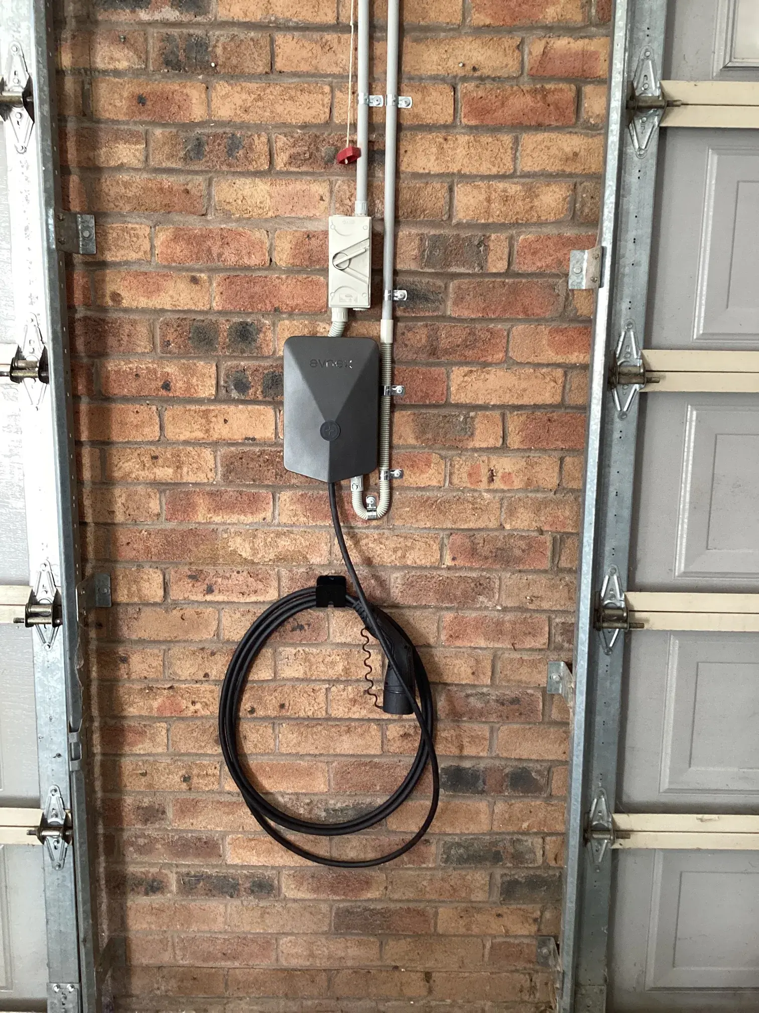 EV charger installed on a brick wall