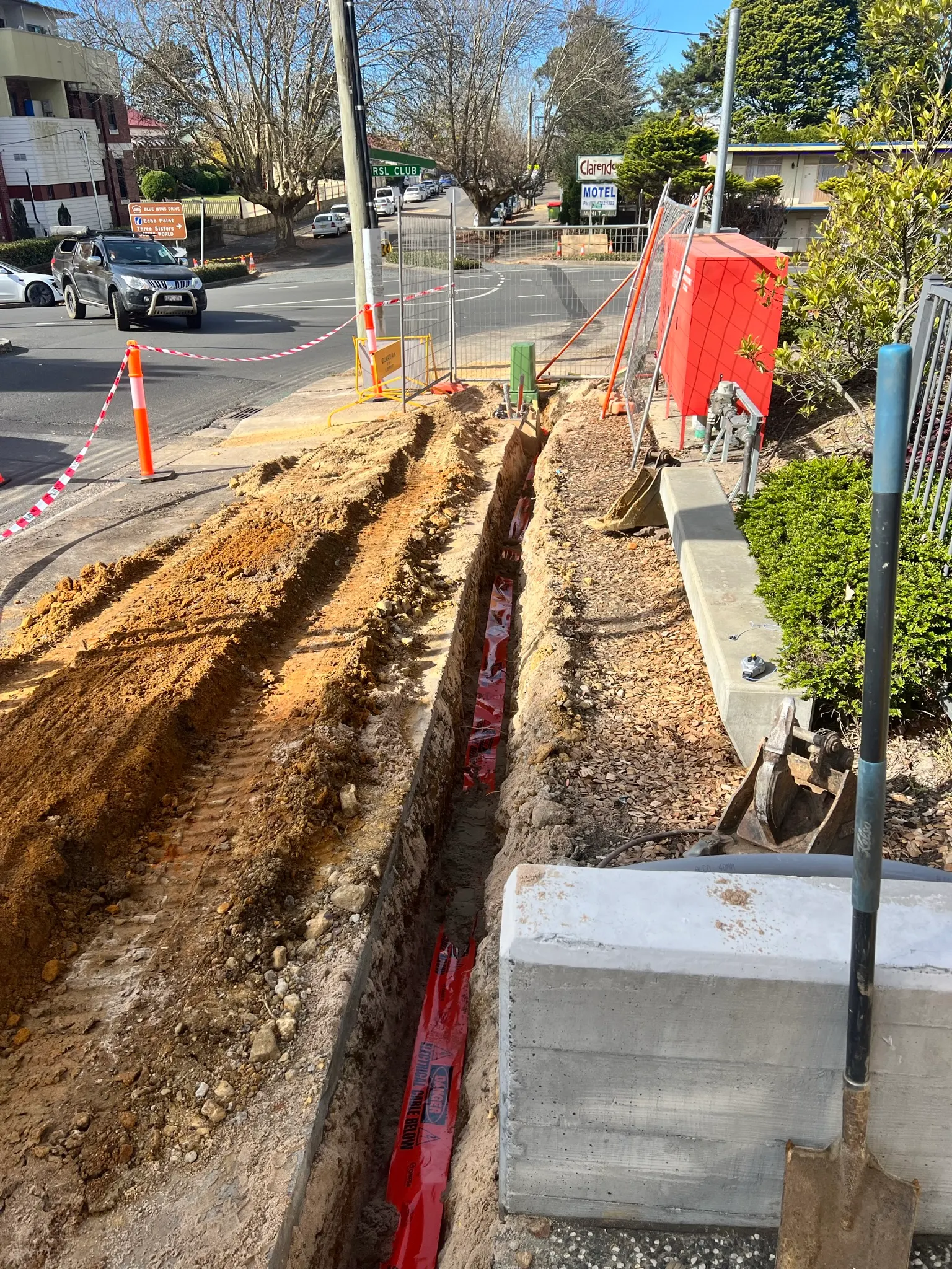 Trench beside the road for new underground service mains