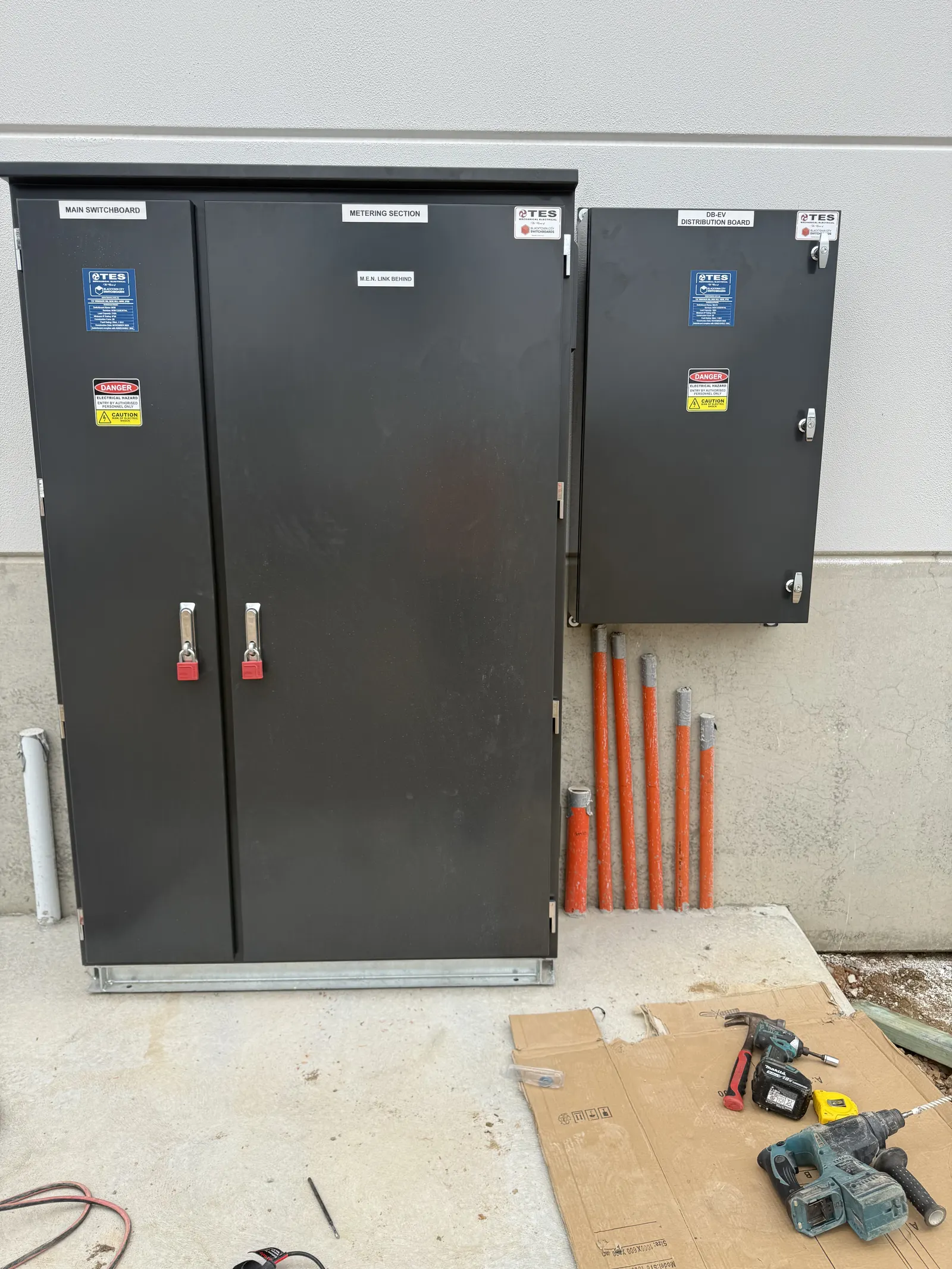 Switch cabinets with orange conduits running in from below