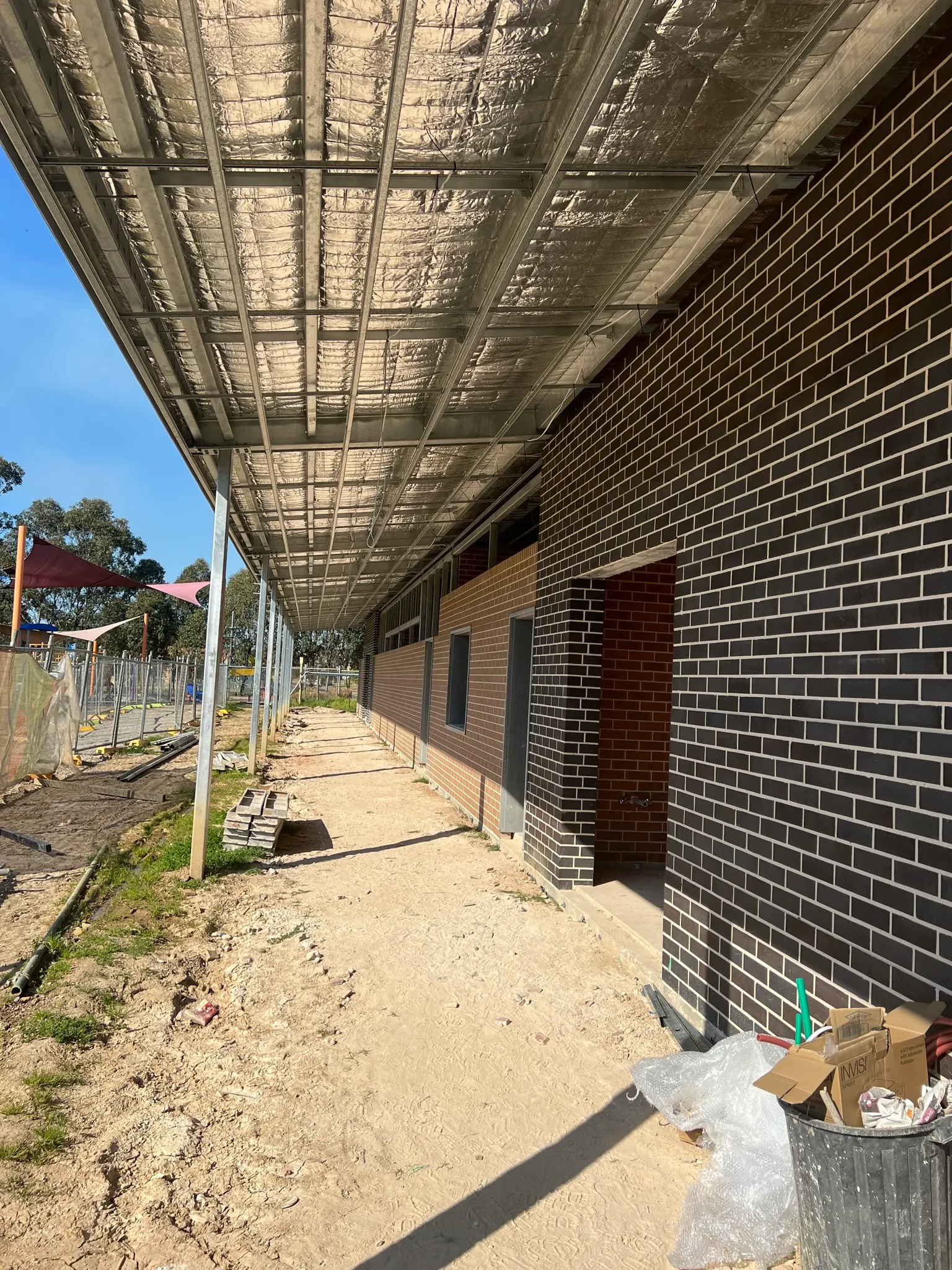 Covered walkway on a commercial building with new lighting
